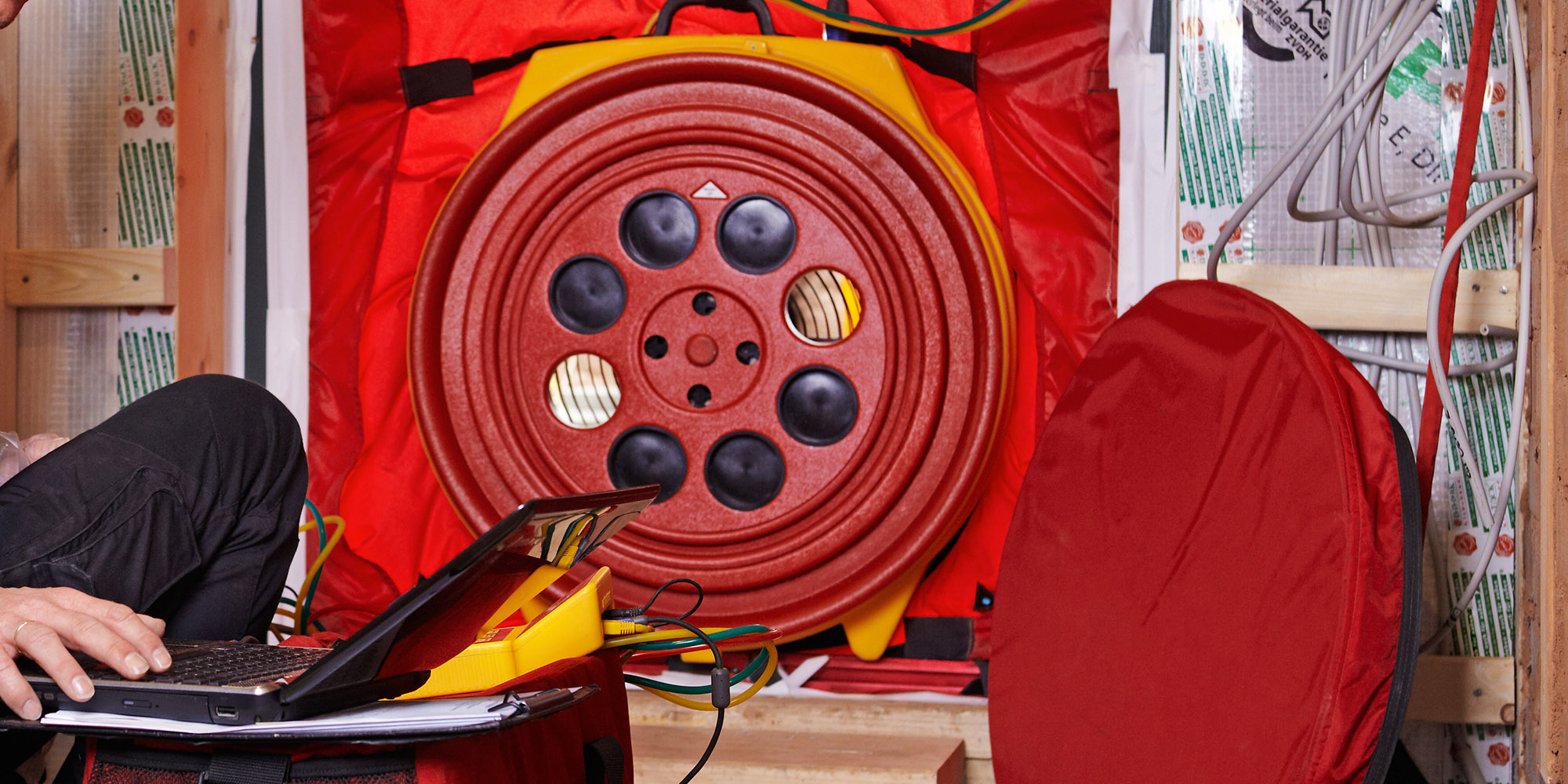 DocAir blower door test installed on an exterior door frame measuring air tightness
